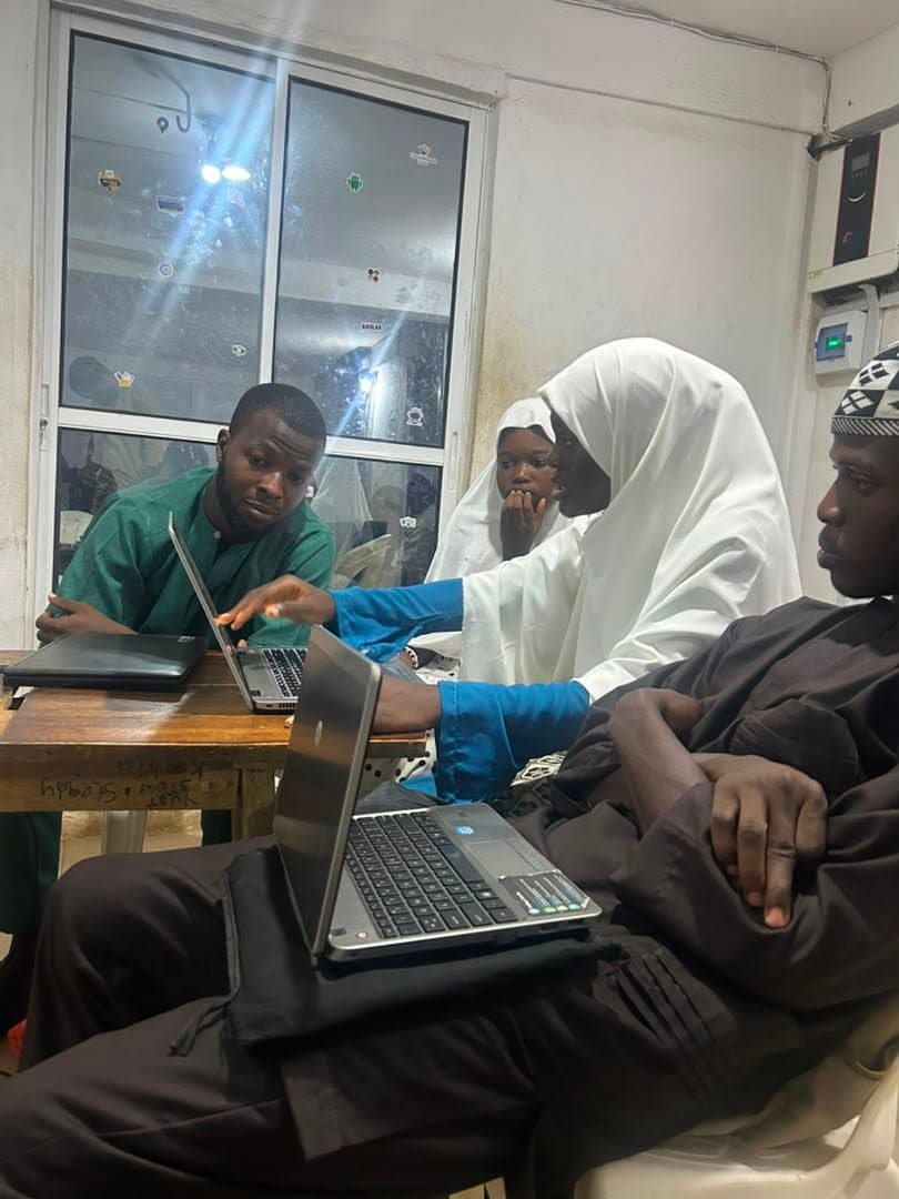 Students reviewing code together on laptops