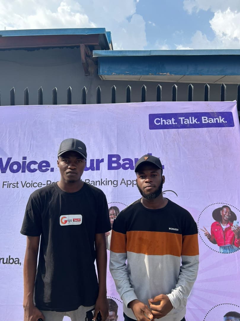 Students in front of a fintech showcase banner at a tech event