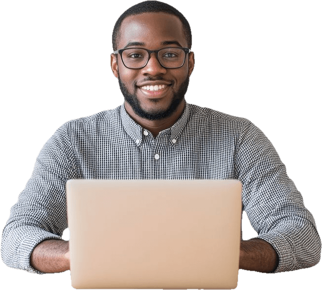 A student smiling while coding on a laptop